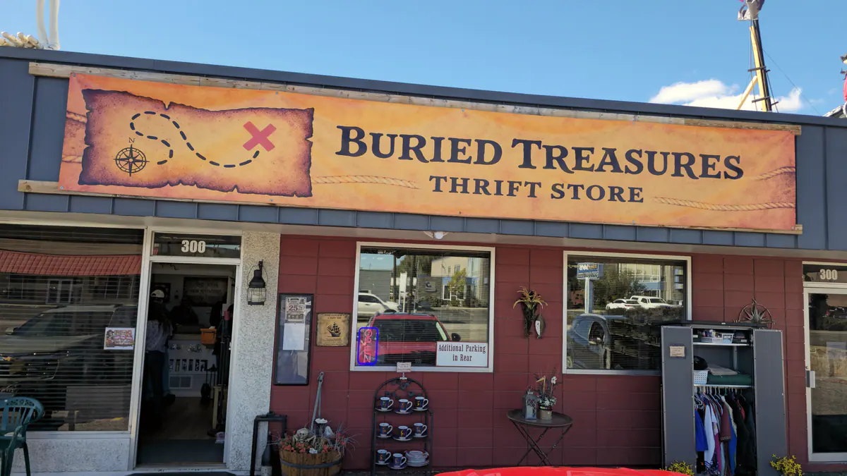 The Buried Treasures Thrift Store storefront and treasure map sign on Moore Lane