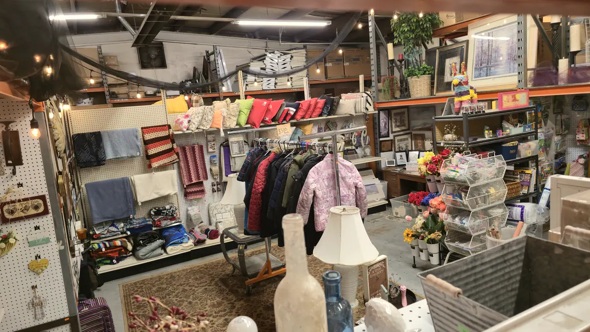 Racks of clothing, lamps and home decor inside Buried Treasures